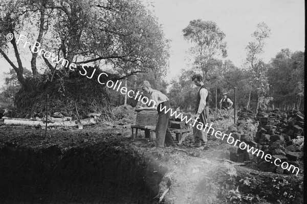 MEN DIGGING PEAT BY HAND